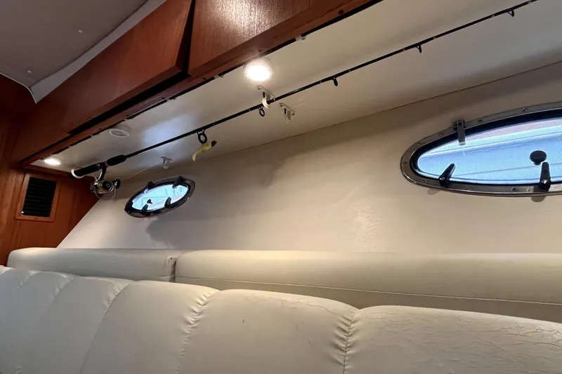 Slide: The Image of Interior of 1999 Tiara Yachts 3500 Open with fishing rod storage and porthole windows. - 7