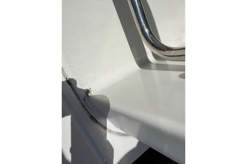 Slide: The Image of Close-up of Jeanneau NC 895 boat detail, featuring a metal railing and textured surface, 2021 model. - 20