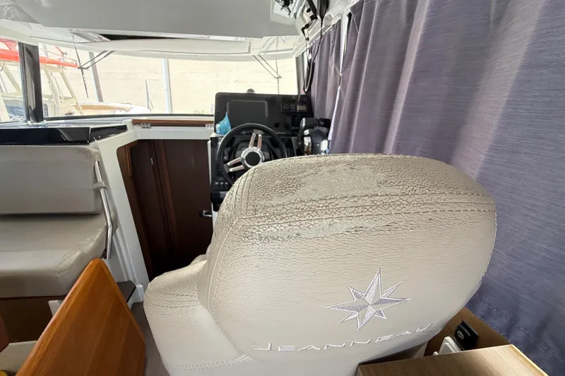 Slide: The Image of Interior of 2021 Jeanneau NC 895 boat showing helm seat and steering wheel. - 23