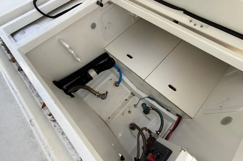 Slide: The Image of 2021 Jeanneau NC 895 boat storage compartment with visible plumbing and wiring. - 30