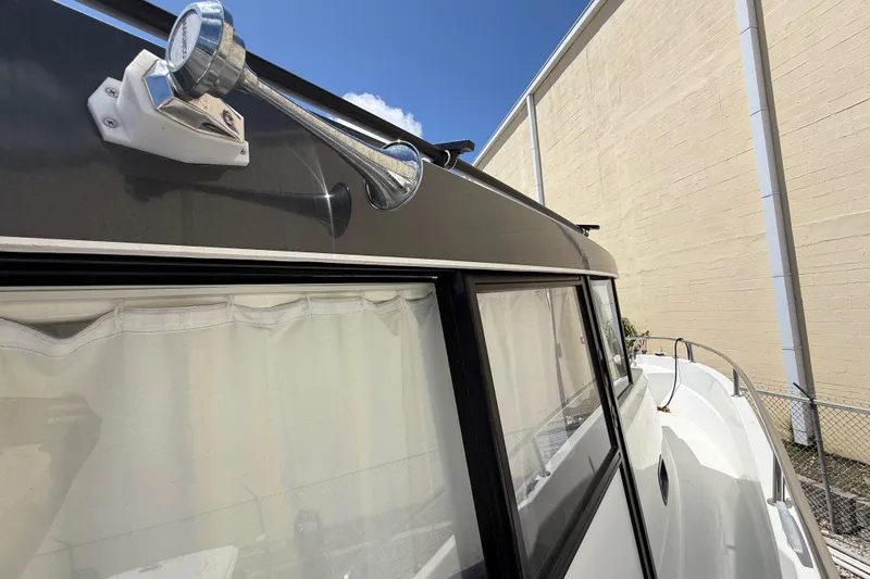 Slide: The Image of 2021 Jeanneau NC 895 boat exterior with horn and windows, docked beside a building. - 35