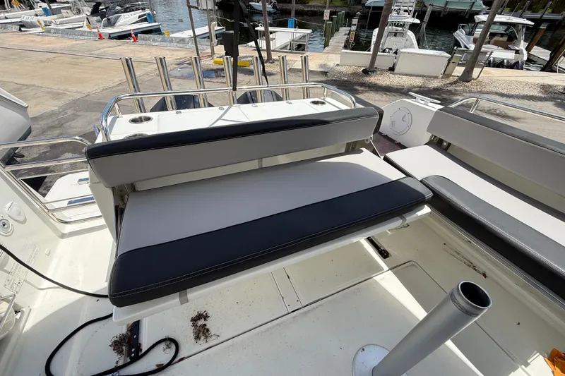 Slide: The Image of 2021 Jeanneau NC 895 boat interior with cushioned seating and rod holders. - 38