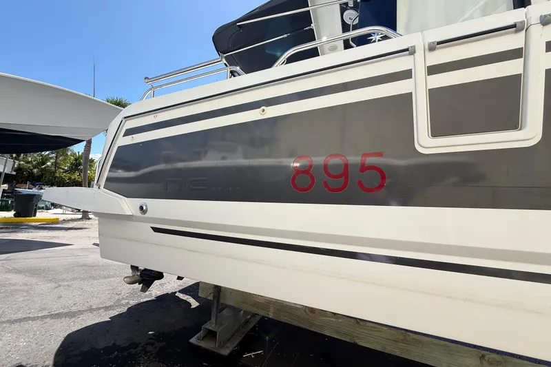 Slide: The Image of 2021 Jeanneau NC 895 boat on display, showcasing sleek design and model number. - 4