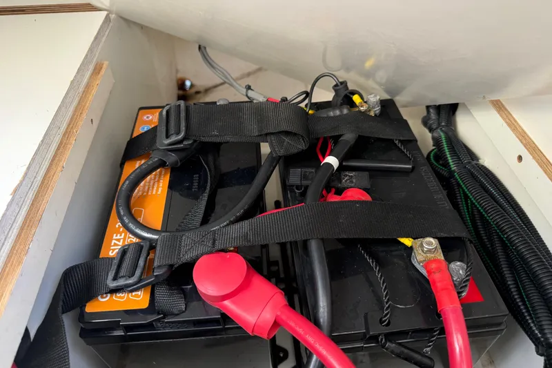 Slide: The Image of Battery compartment of a 2021 Jeanneau NC 895 boat with secured cables. - 41