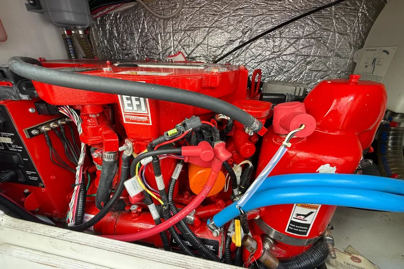 Slide: The Image of Engine compartment of a 2021 Jeanneau NC 895 boat, featuring red EFI components. - 42