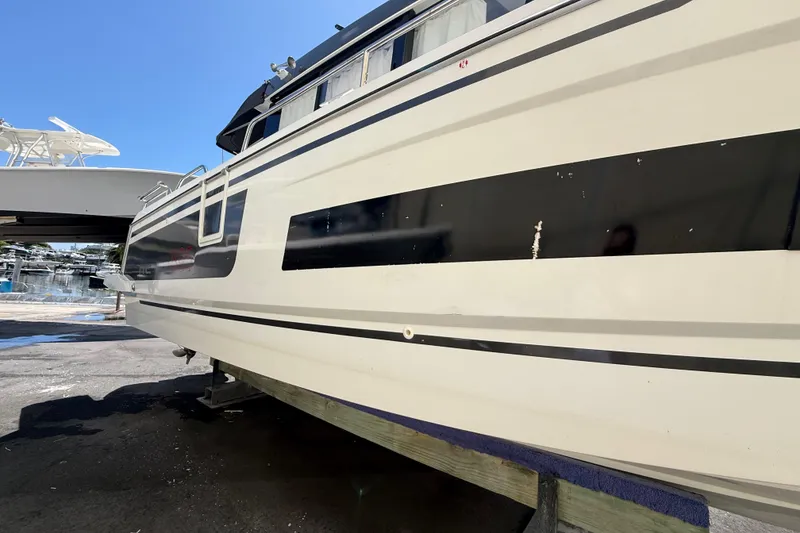 Slide: The Image of 2021 Jeanneau NC 895 boat on dry dock under clear blue sky. - 5