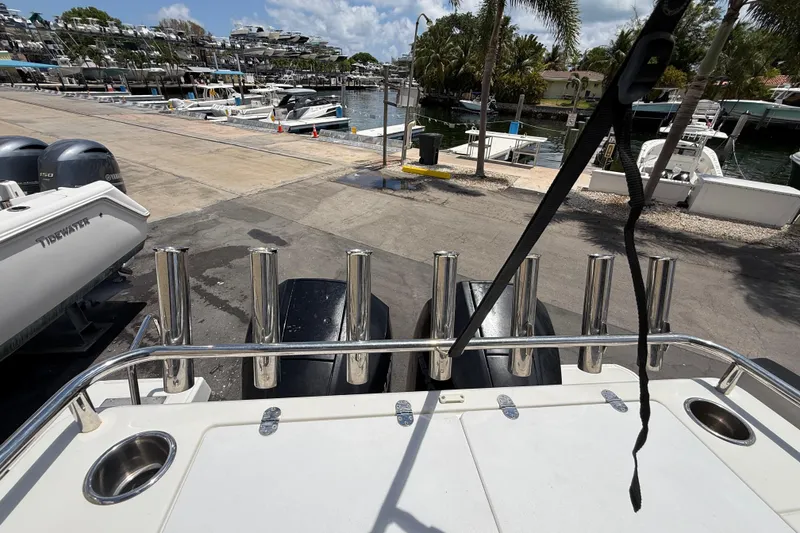 Slide: The Image of 2021 Jeanneau NC 895 boat at marina with rod holders and outboard engines. - 50
