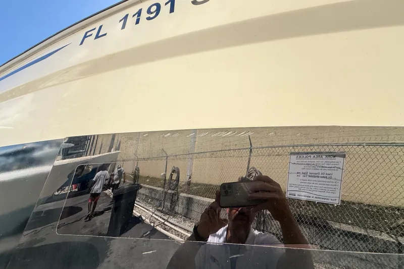 Slide: The Image of 2021 Jeanneau NC 895 boat with reflective surface and visible registration number. - 7