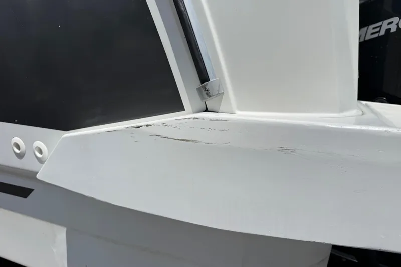 Slide: The Image of 2021 Jeanneau NC 895 boat with visible scratches on the white hull. - 9