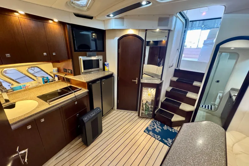 Slide: The Image of Luxurious interior of 2012 Cruisers Yachts 430 Sports Coupe with modern kitchen amenities. - 11