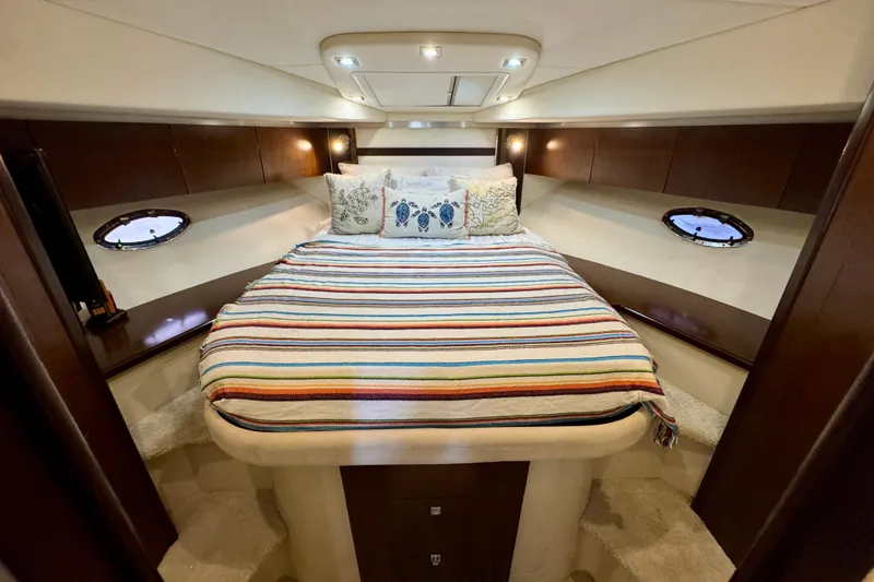 Slide: The Image of Luxurious 2012 Cruisers Yachts 430 Sports Coupe cabin with cozy bed and elegant decor. - 14