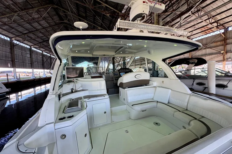 Slide: The Image of 2012 Cruisers Yachts 430 Sports Coupe in marina, featuring spacious seating and modern amenities. - 3