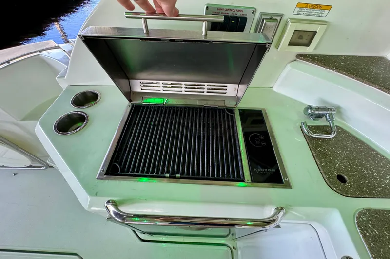 Slide: The Image of Outdoor grill on 2012 Cruisers Yachts 430 Sports Coupe, featuring stainless steel design and control panel. - 7