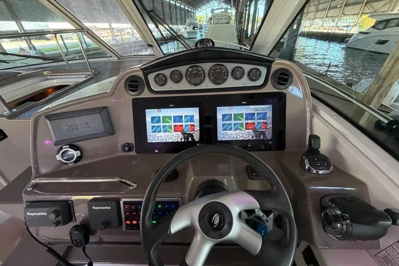 Slide: The Image of 2012 Cruisers Yachts 430 Sports Coupe helm with dual screens and navigation controls. - 9