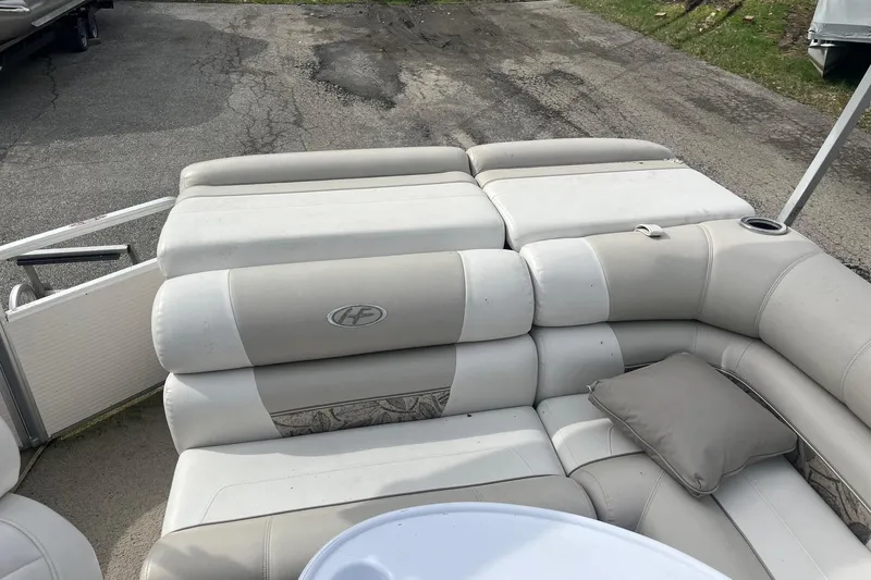 Slide: The Image of 2008 Harris Super Sunliner 240 boat interior with beige seating and cushion. - 11