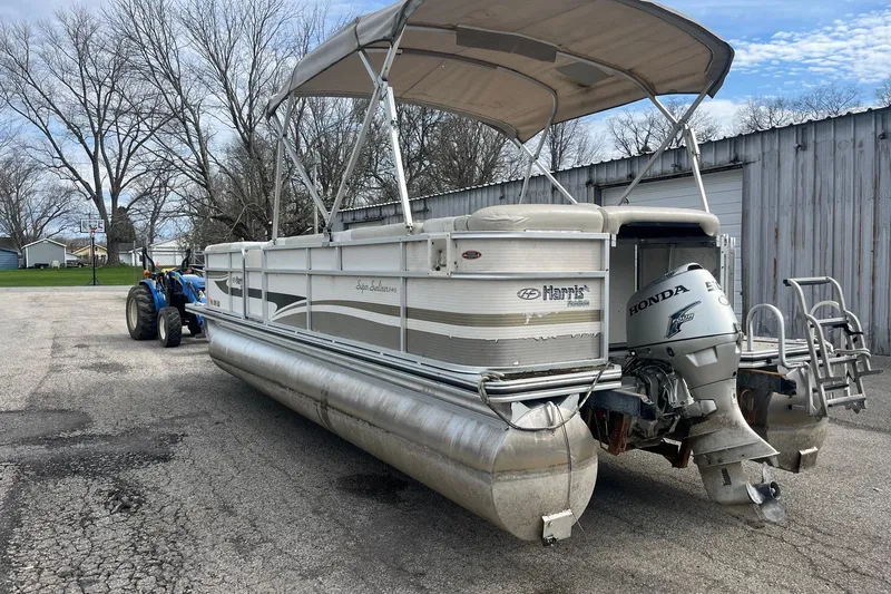 Slide: The Image of 2008 Harris Super Sunliner 240 pontoon boat with Honda outboard motor on trailer. - 3