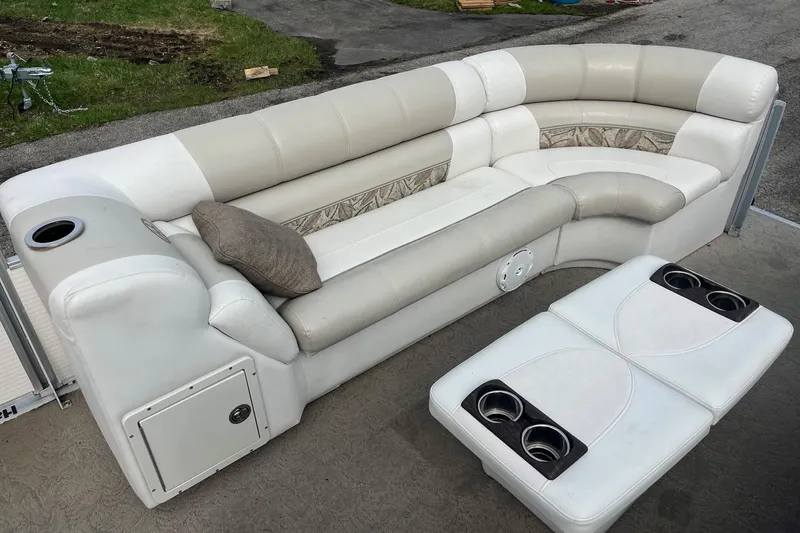 Slide: The Image of 2008 Harris Super Sunliner 240 boat seating with cup holders and a cushion on a sunny day. - 6