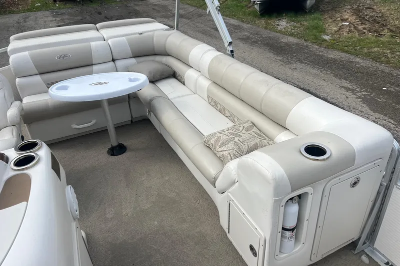 Slide: The Image of 2008 Harris Super Sunliner 240 pontoon boat interior with beige seating and table. - 8
