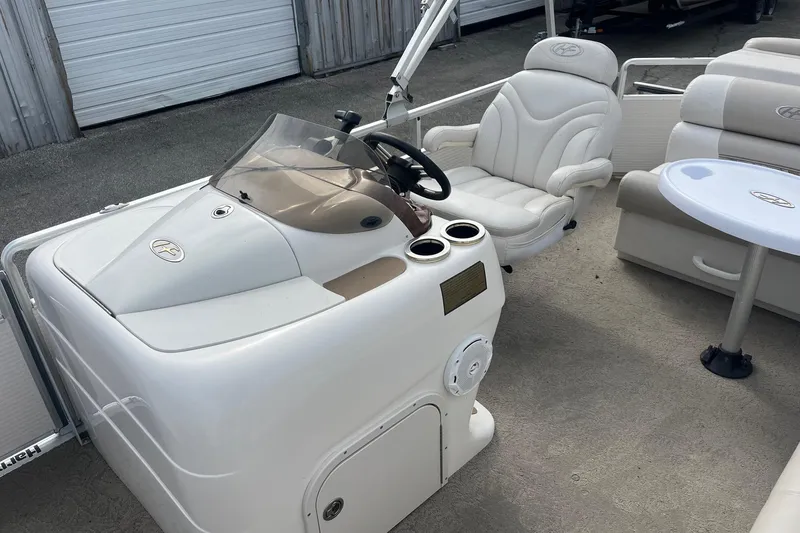 Slide: The Image of 2008 Harris Super Sunliner 240 boat interior with helm, seating, and table. - 9