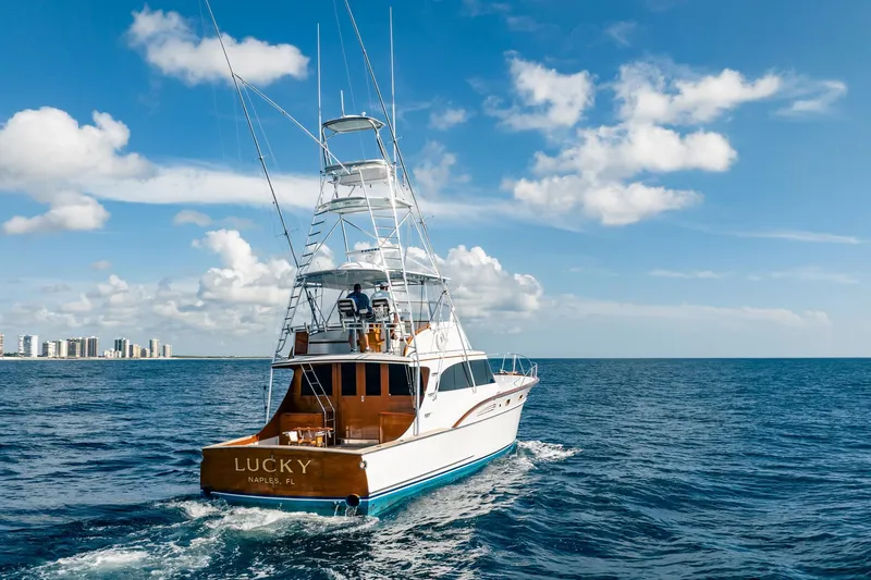 Slide: The Image of 1983 Rybovich 55 Convertible yacht cruising on open sea under blue sky. - 108
