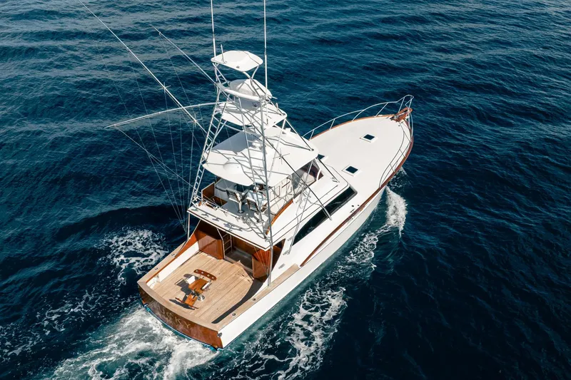 Slide: The Image of 1983 Rybovich 55 Convertible yacht cruising on open sea, aerial view. - 116