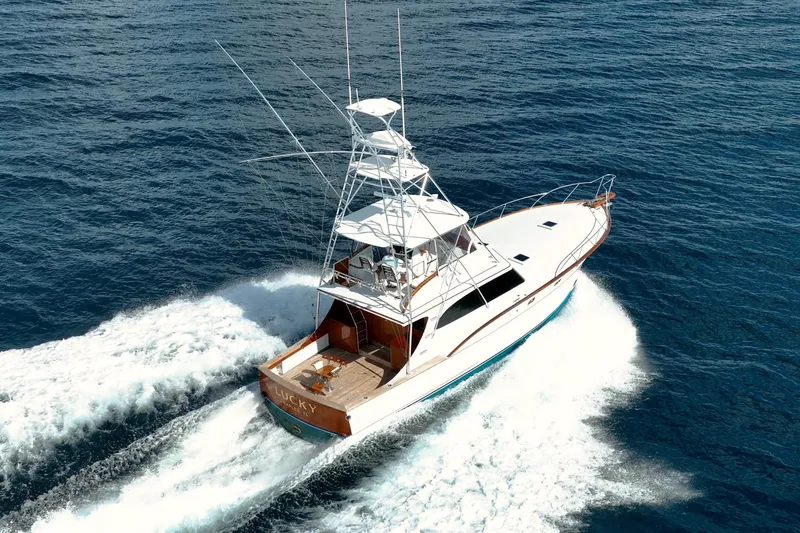 Slide: The Image of 1983 Rybovich 55 Convertible yacht cruising on open ocean waters. - 122