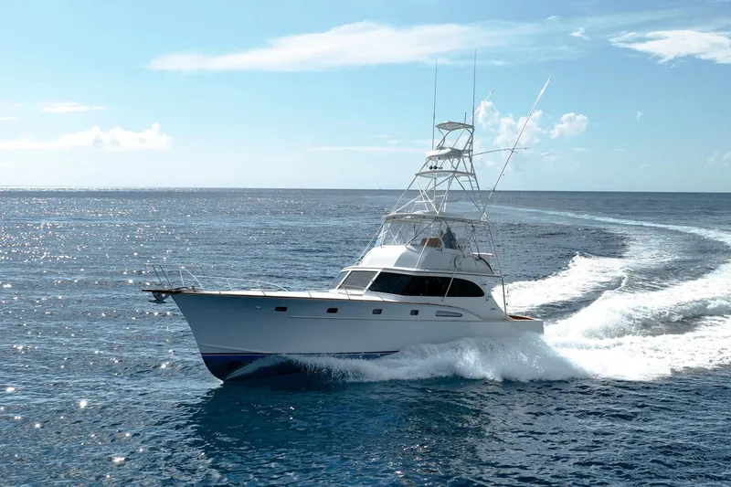Slide: The Image of 1983 Rybovich 55 Convertible yacht cruising on open ocean waters. - 125