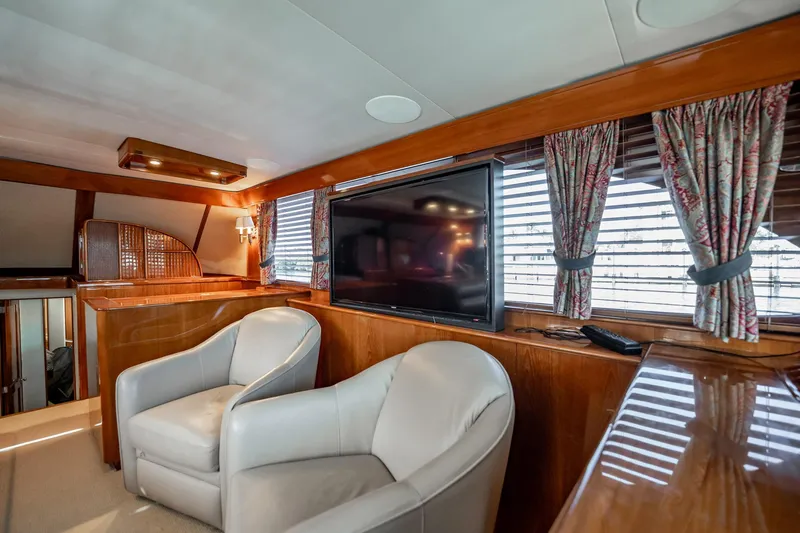 Slide: The Image of Luxurious interior of 1983 Rybovich 55 Convertible yacht with leather chairs and large TV. - 14