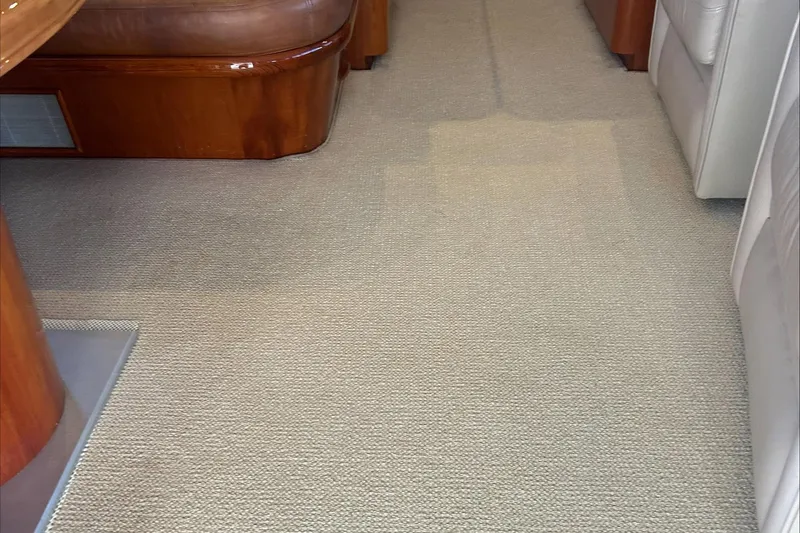 Slide: The Image of Interior of 1983 Rybovich 55 Convertible yacht with beige carpet and wooden furniture. - 15