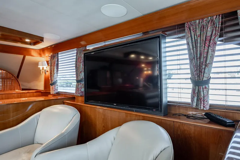 Slide: The Image of Luxurious interior of 1983 Rybovich 55 Convertible yacht with TV and leather seating. - 16