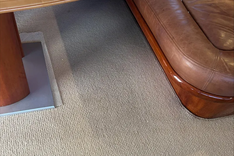 Slide: The Image of Interior of 1983 Rybovich 55 Convertible, featuring leather seating and wooden table. - 18