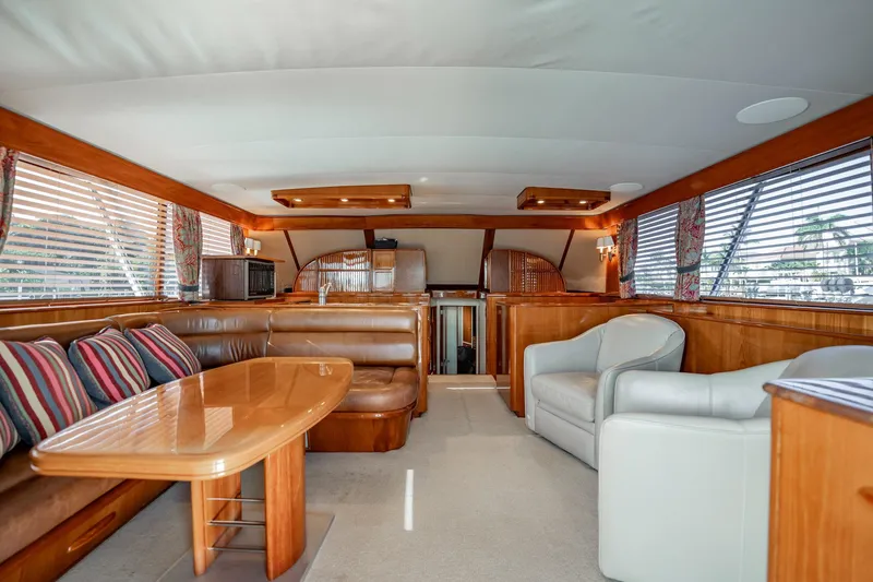 Slide: The Image of Luxurious interior of 1983 Rybovich 55 Convertible yacht with elegant wood finishes and seating. - 20