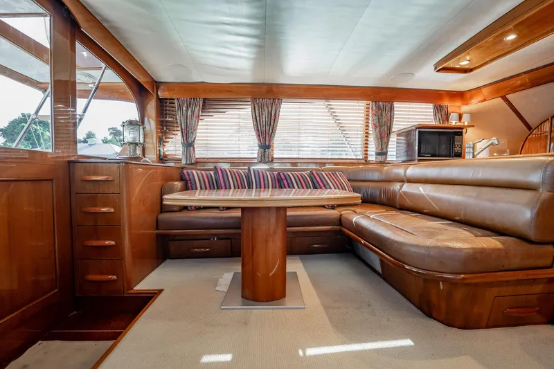 Slide: The Image of Luxurious interior of 1983 Rybovich 55 Convertible yacht with leather seating and wooden accents. - 22