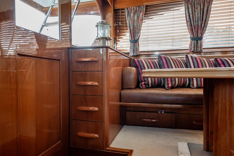 Slide: The Image of Interior of 1983 Rybovich 55 Convertible yacht with wood finish and striped cushions. - 23