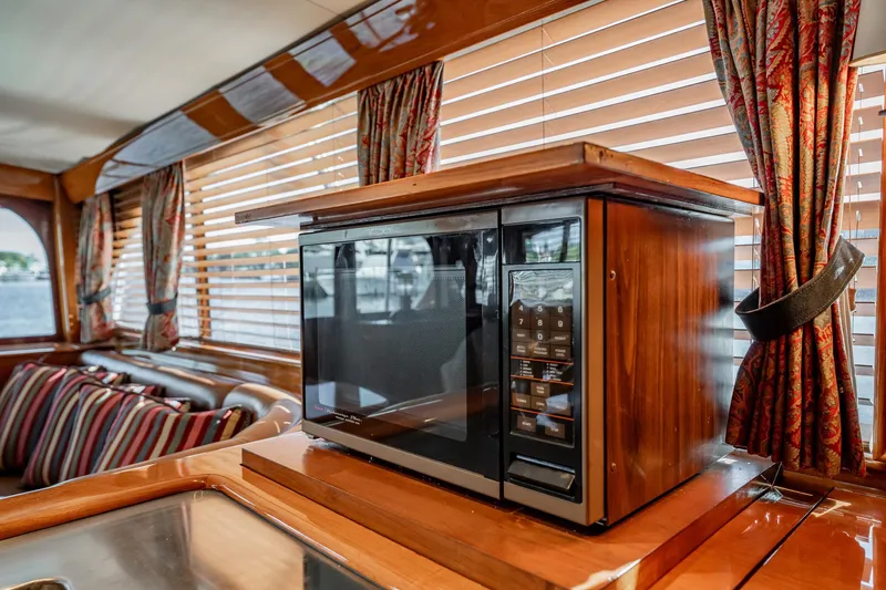 Slide: The Image of Luxurious interior of 1983 Rybovich 55 Convertible yacht with microwave and elegant wood finish. - 27