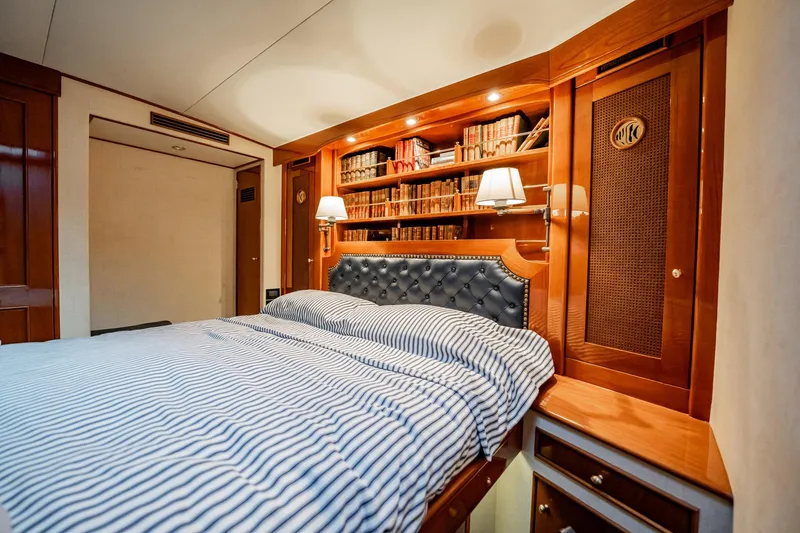 Slide: The Image of Luxurious cabin interior of 1983 Rybovich 55 Convertible yacht with elegant woodwork and cozy bedding. - 34