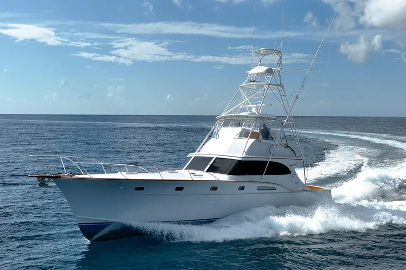 Slide: The Image of 1983 Rybovich 55 Convertible yacht cruising on open ocean waters. - 4
