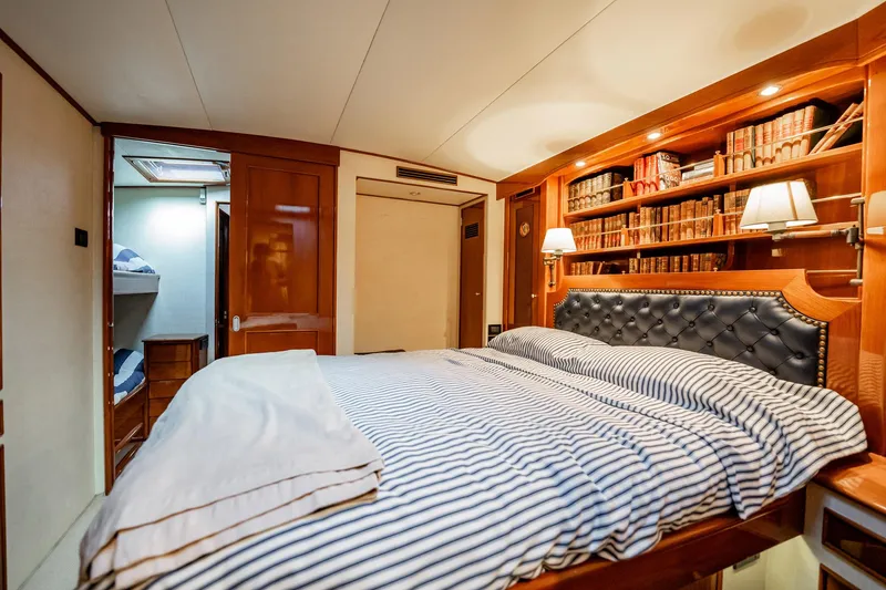 Slide: The Image of Luxurious cabin interior of 1983 Rybovich 55 Convertible yacht with cozy bed and bookshelf. - 40