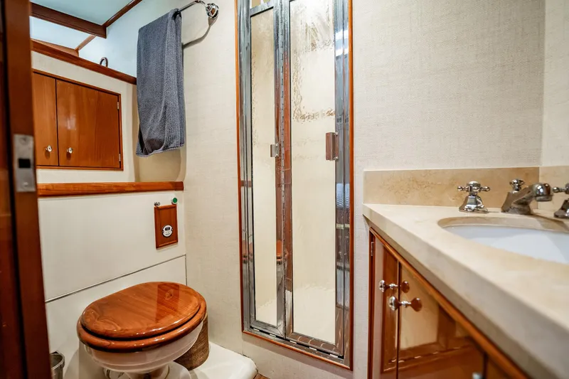 Slide: The Image of Luxurious bathroom in 1983 Rybovich 55 Convertible yacht with wood accents and modern fixtures. - 42