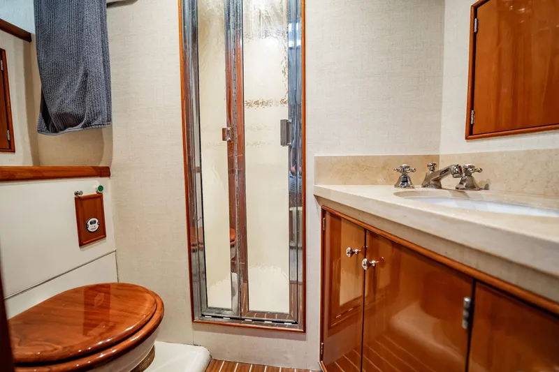 Slide: The Image of Luxurious bathroom interior of 1983 Rybovich 55 Convertible yacht with wood accents. - 43