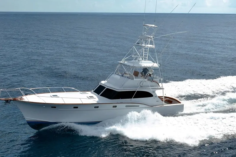 Slide: The Image of 1983 Rybovich 55 Convertible yacht cruising on open ocean waters. - 5