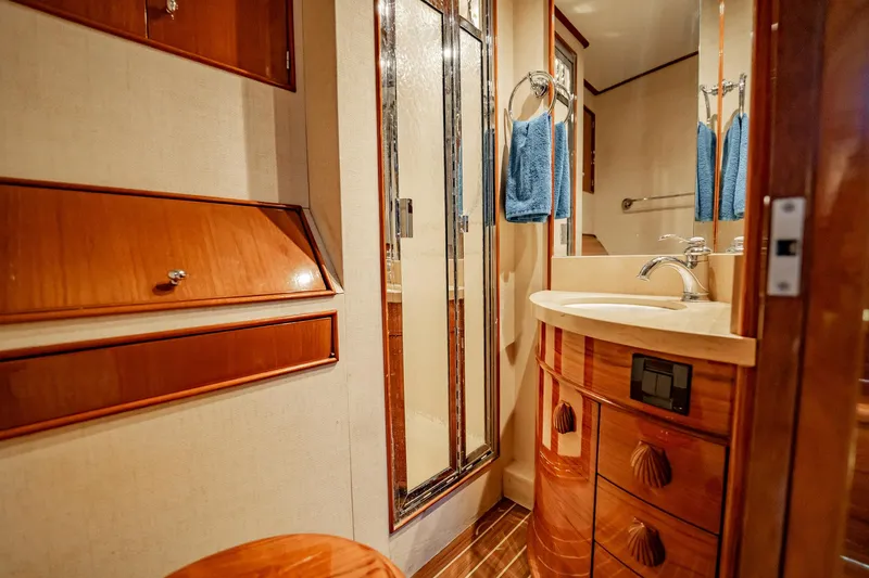 Slide: The Image of Luxurious bathroom interior of 1983 Rybovich 55 Convertible yacht with wood accents. - 50