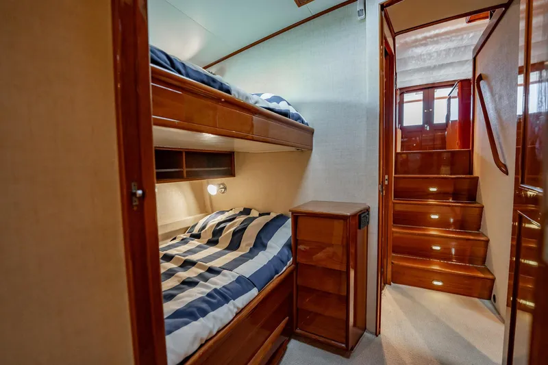 Slide: The Image of Interior of 1983 Rybovich 55 Convertible yacht with bunk beds and wooden stairs. - 52