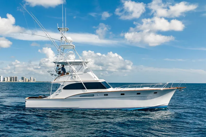 Slide: The Image of 1983 Rybovich 55 Convertible yacht cruising on open sea under blue sky. - 6