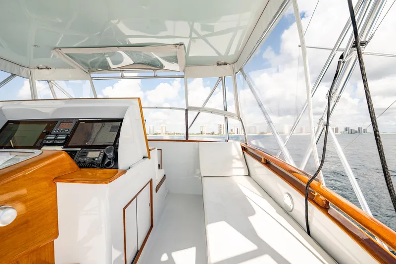 Slide: The Image of 1983 Rybovich 55 Convertible yacht interior with navigation controls and ocean view. - 65