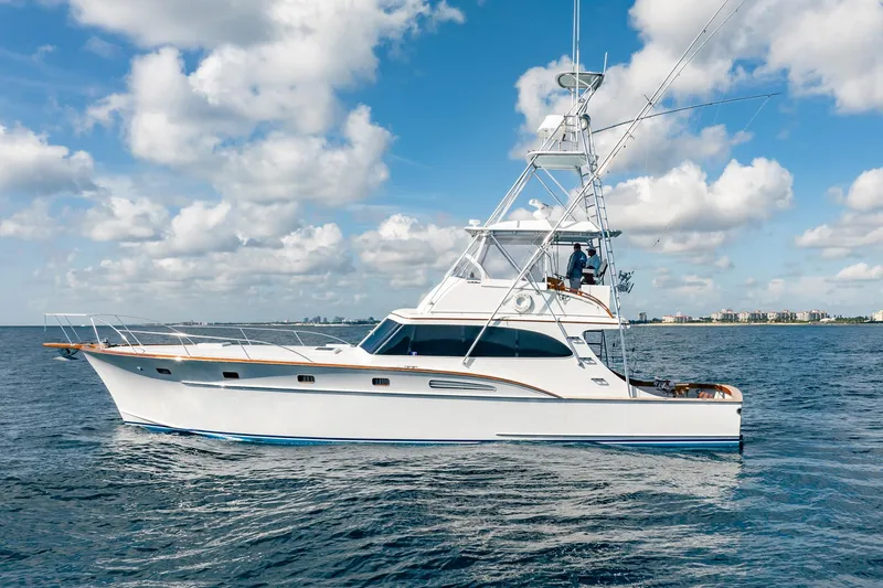 Slide: The Image of 1983 Rybovich 55 Convertible yacht on open water under a blue sky. - 7