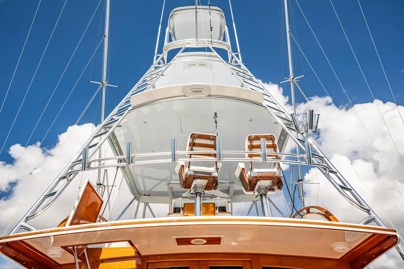 Slide: The Image of 1983 Rybovich 55 Convertible yacht, tower view against blue sky and clouds. - 72