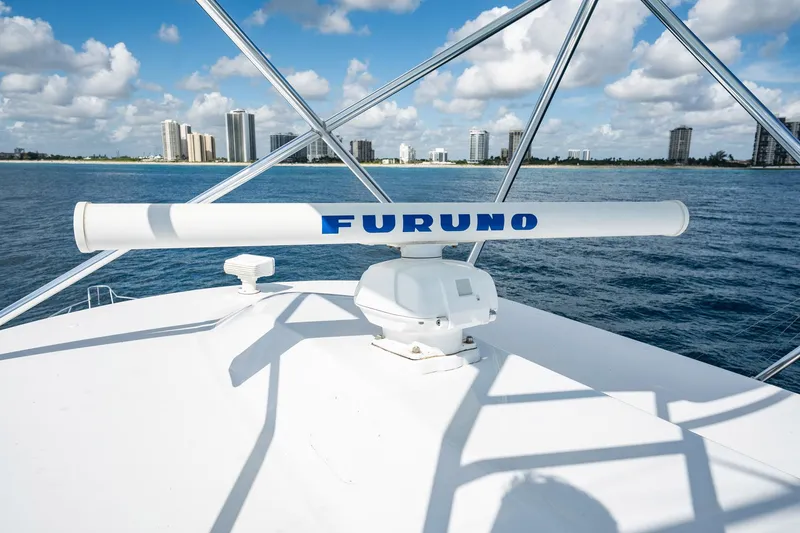Slide: The Image of 1983 Rybovich 55 Convertible yacht with Furuno radar, ocean view, city skyline in background. - 73