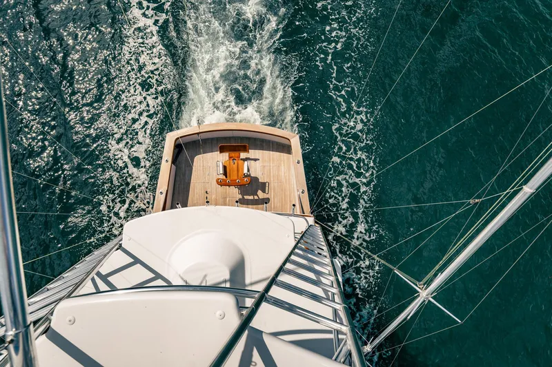Slide: The Image of Aerial view of 1983 Rybovich 55 Convertible yacht cruising on open water. - 79