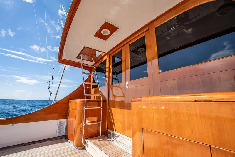 Slide: The Image of 1983 Rybovich 55 Convertible yacht deck with wooden finish and ocean view. - 83